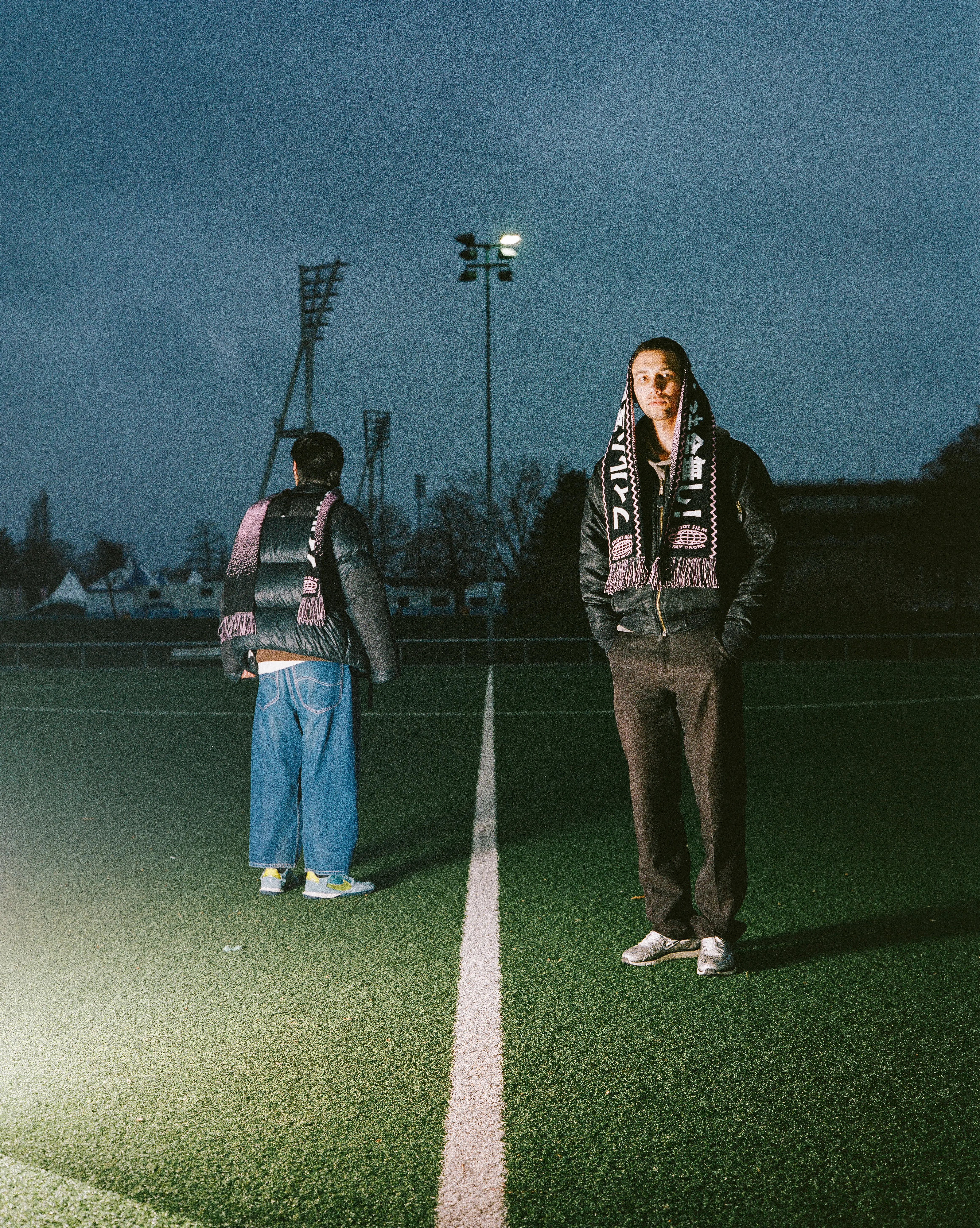 Wearing the safelight football scarf in a football field wide shot